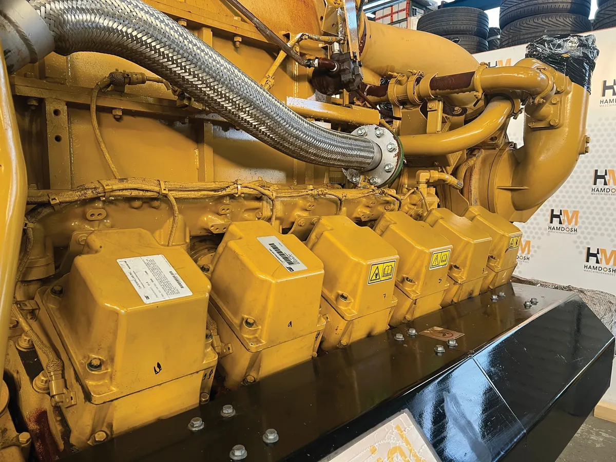 Bank of Caterpillar diesel engines being prepared for generating set assembly