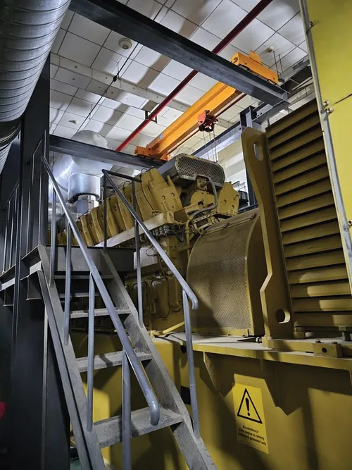 Installed generating set with access stairs inside a client plant room